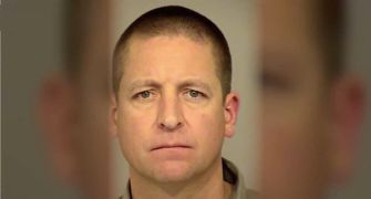 Mugshot of a man with short hair and a neutral expression.