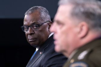 Image of U.S. Secretary of Defense Lloyd J. Austin III and a military officer during a press conference, discussing new sexual assault resolution procedures in the military.