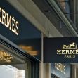 Signage for Hermès store in Paris, highlighting the luxury brand's name. Signage for Hermès store in Paris, highlighting the luxury brand's name.