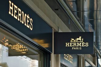 Signage for Hermès store in Paris, highlighting the luxury brand's name.
