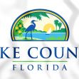 Lake County, Florida emblem featuring a heron, palm trees, and a scenic background. Lake County, Florida emblem featuring a heron, palm trees, and a scenic background.