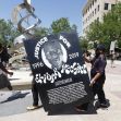 A protester holds a sign reading "Justice for Elijah McClain" during a demonstration. A protester holds a sign reading "Justice for Elijah McClain" during a demonstration.