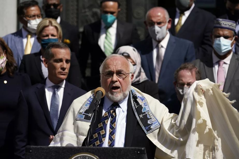 Rabbi Abraham Cooper, center, of the Simon Wiesenthal Center, speaks in front of civic and faith leaders outside the Los Angeles City Hall, May 20, 2021. (AP Photo/Marcio Jose Sanchez)