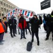 A group of protesters gathers in the snow, holding signs in support of Black Lives Matter and opposing police actions. A group of protesters gathers in the snow, holding signs in support of Black Lives Matter and opposing police actions.