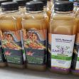 Bottles of Earth Tea displayed on a table, marketed as a natural remedy. Bottles of Earth Tea displayed on a table, marketed as a natural remedy.