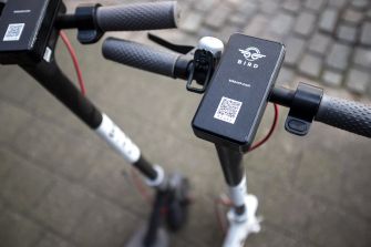 Close-up of handlebars of a Bird electric scooter, showcasing the QR code and control panel.
