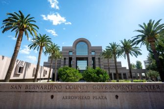 San Bernardino County Government Center, featuring palm trees and a modern architectural design.