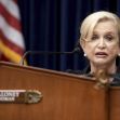 Democratic Representative Carolyn Maloney speaking at a congressional hearing, with an American flag in the background. Democratic Representative Carolyn Maloney speaking at a congressional hearing, with an American flag in the background.