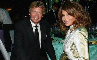Image of Paula Abdul and Nigel Lythgoe at an event, both dressed formally.