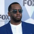 Sean "Diddy" Combs at a public event, wearing sunglasses and a blue suit. Sean "Diddy" Combs at a public event, wearing sunglasses and a blue suit.