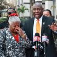 A civil rights attorney speaks during a press conference alongside a woman visibly emotional after filing a lawsuit against a Central Florida credit union. A civil rights attorney speaks during a press conference alongside a woman visibly emotional after filing a lawsuit against a Central Florida credit union.