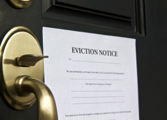 Eviction notice posted on a door, signaling the termination of tenancy.