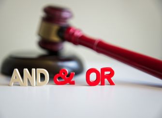 A gavel alongside the words "AND," "&," and "OR," illustrating the legal debate over language interpretation in the Supreme Court case regarding the First Step Act.