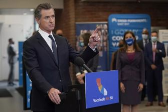 Governor Gavin Newsom announcing California's vaccine mandate for public workers during a press conference.