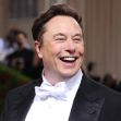 Elon Musk smiling at a public event, wearing a tuxedo with a bow tie. Elon Musk smiling at a public event, wearing a tuxedo with a bow tie.