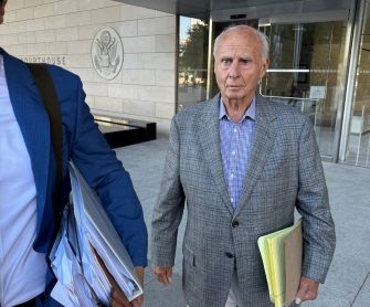 Disbarred attorney Tom Girardi leaving a courthouse, facing serious allegations related to financial misconduct.