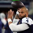 NFL quarterback Dak Prescott throws a football during warm-ups on the field. NFL quarterback Dak Prescott throws a football during warm-ups on the field.