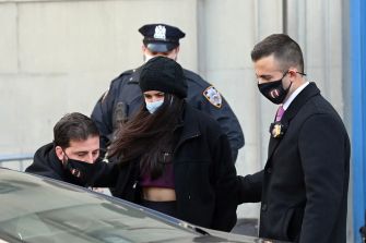 Miya Ponsetto being escorted by law enforcement officers following her arrest.