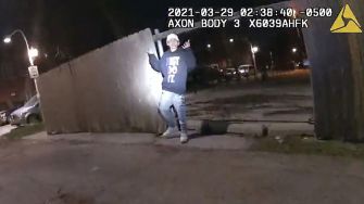 Bodycam footage from the police incident involving 13-year-old Adam Toledo, showing him with raised hands in a dark alley.