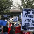Protesters rally outside a courthouse holding signs advocating to cancel rents and stop evictions and foreclosures. Protesters rally outside a courthouse holding signs advocating to cancel rents and stop evictions and foreclosures.