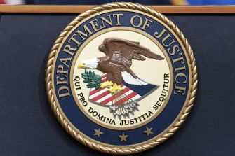Seal of the U.S. Department of Justice on a backdrop.