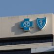 The logo of Blue Cross Blue Shield displayed on a building exterior. The logo of Blue Cross Blue Shield displayed on a building exterior.