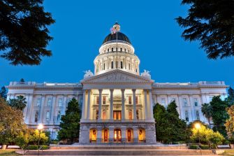 California State Capitol building illuminated at dusk.