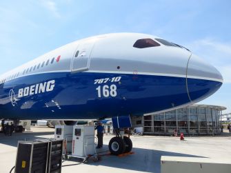 Boeing 787-10 aircraft displayed at an event, showcasing its design and branding.
