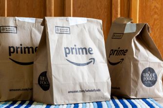 Brown paper bags with "prime" and "whole foods" branding on them.
