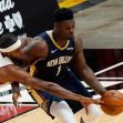 Zion Williamson in action during a basketball game, competing for possession of the ball. Zion Williamson in action during a basketball game, competing for possession of the ball.