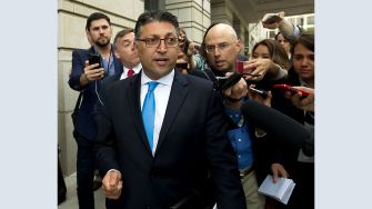 Makan Delrahim, the former Assistant Attorney General for the Antitrust Division, surrounded by reporters as he leaves the DOJ.