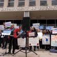 A crowd of protesters outside the U.S. Department of Education, holding signs advocating for education funding and diversity programs. A crowd of protesters outside the U.S. Department of Education, holding signs advocating for education funding and diversity programs.