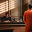 A judge listens to a man in an orange jumpsuit during a court proceeding. A judge listens to a man in an orange jumpsuit during a court proceeding.