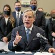 Texas Governor Greg Abbott speaking at a press conference about the law banning vaccine passports, with other officials in the background. Texas Governor Greg Abbott speaking at a press conference about the law banning vaccine passports, with other officials in the background.