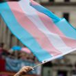 Transgender pride flag being waved at a public event. Transgender pride flag being waved at a public event.