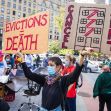 Protestors hold signs advocating against evictions and calling for rent cancellation during a demonstration. Protestors hold signs advocating against evictions and calling for rent cancellation during a demonstration.