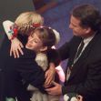 Young figure skater receiving congratulations from coaches after a performance. Young figure skater receiving congratulations from coaches after a performance.