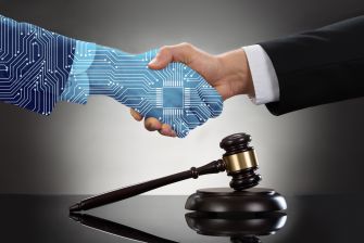 A digital hand with circuit patterns shaking hands with a human hand in a professional setting, alongside a gavel.