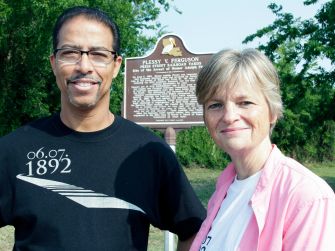 Keith Plessy and Phoebe Ferguson pose in front of the historical marker for Plessy v. Ferguson.