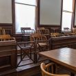 Empty jury box with wooden chairs in a courtroom setting. Empty jury box with wooden chairs in a courtroom setting.