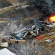 Aerial view of a train derailment site in East Palestine, Ohio, showing smoke and flames from burning tank cars. Aerial view of a train derailment site in East Palestine, Ohio, showing smoke and flames from burning tank cars.