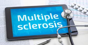 Image of a tablet displaying the text "Multiple sclerosis" alongside medical papers and a stethoscope.