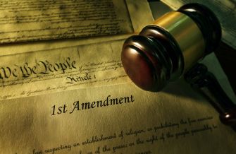 Image depicting the U.S. Constitution with a focus on the First Amendment and a gavel.
