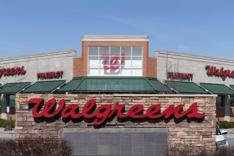 Walgreens store front with prominent signage against a blue sky.