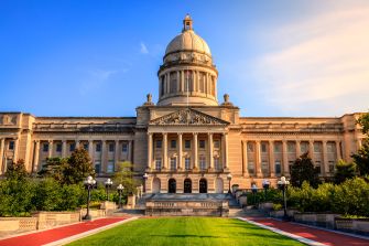 The exterior view of the Kentucky State Capitol building under a clear blue sky.