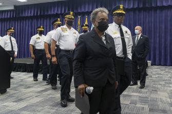 A group of Chicago police officials and city leaders during a press conference addressing vaccine mandate tensions.