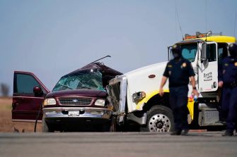 A damaged SUV is seen after a collision with a tractor-trailer in California, where 25 immigrants were being smuggled.