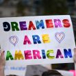 A protest sign that reads "DREAMERS ARE AMERICAN" in colorful letters. A protest sign that reads "DREAMERS ARE AMERICAN" in colorful letters.