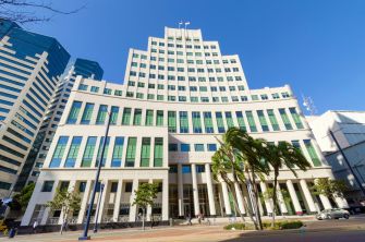 Image of the California Supreme Court building, showcasing its modern architecture against a clear blue sky.