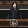 Governor Kathy Hochul speaking at a podium in a legislative setting. Governor Kathy Hochul speaking at a podium in a legislative setting.